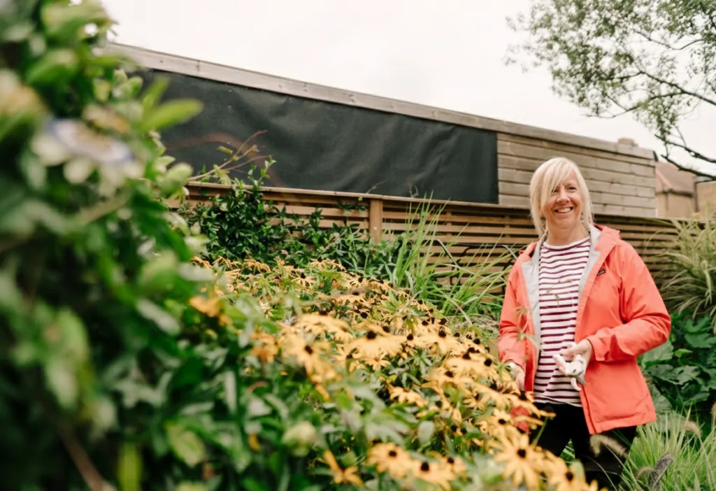 Woman in sunflower garden with flowers
